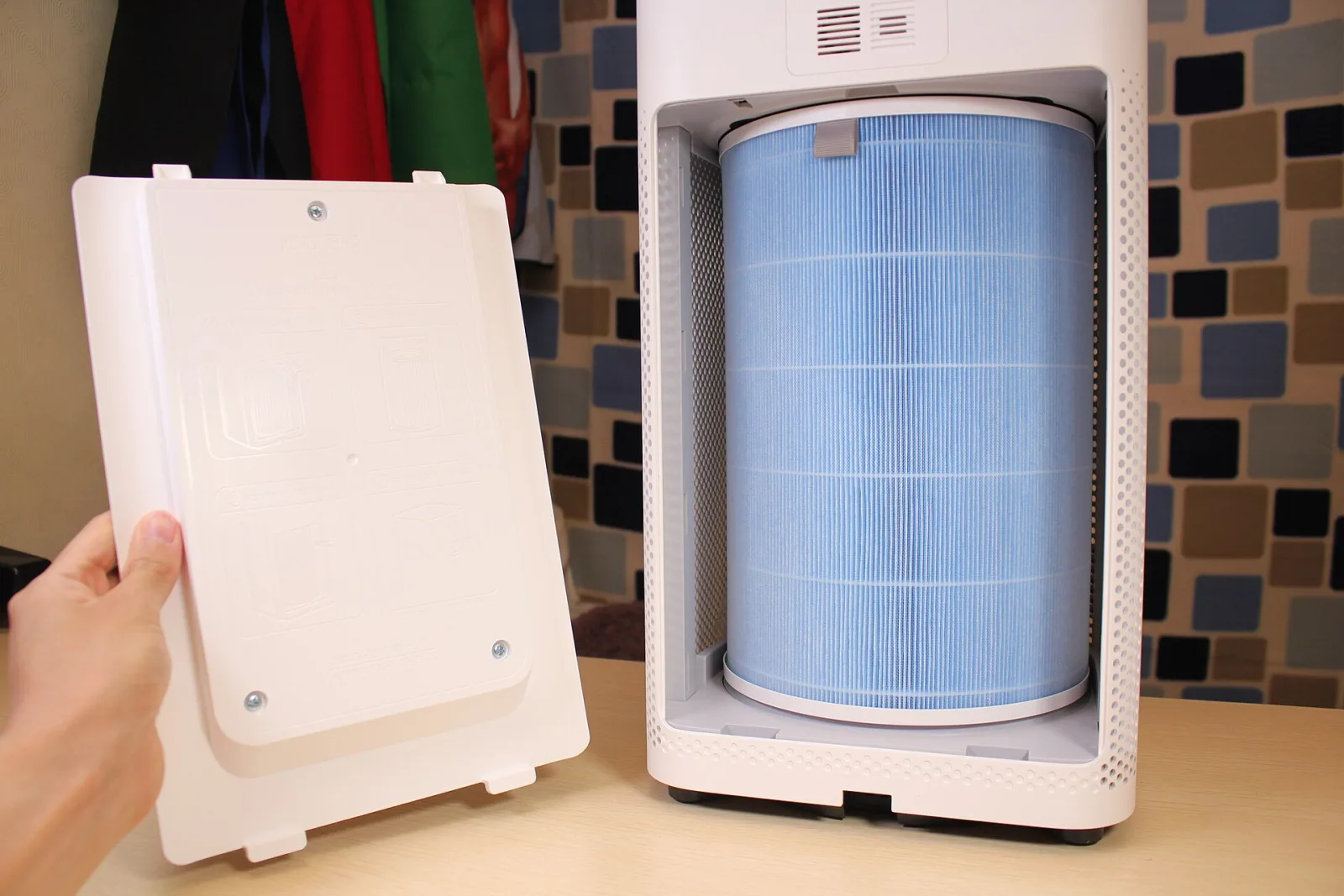 Air purifier with the cover removed showing a cylindrical HEPA filter